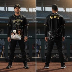 Ella Langley Atlanta Braves Baseball Jersey. Black jersey featuring Ella Langley with dandelion, butterflies, signature on front; 'BRAVES' & flying seeds on back.